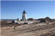 Light House with Dirt Piles Surrounding It